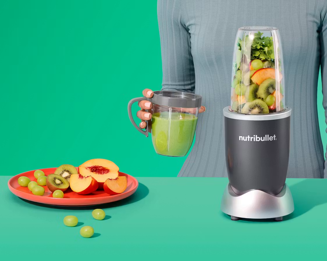 making a green fruit smoothie in a grey nutribullet personal blender