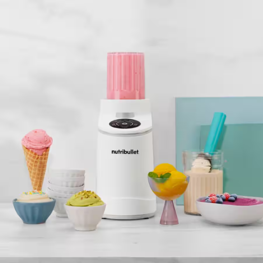 white nutribullet Chill on marble kitchen countertop surrounded by a variety of homemade ice cream flavors