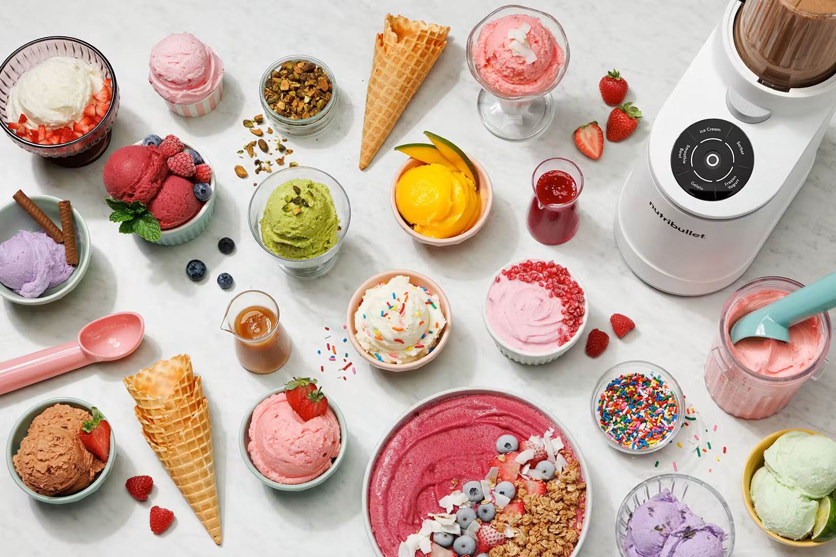 bird's eye view of bowls of ice cream flavors and a variety of toppings