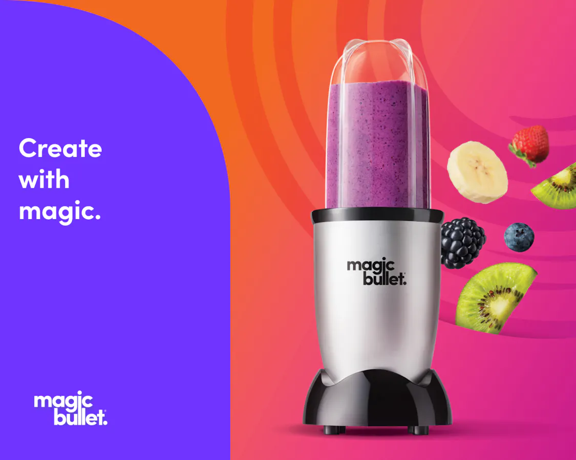 Silver magic bullet blender filled with a purple berry smoothie next to flying fruit pieces and text reading Create with magic.