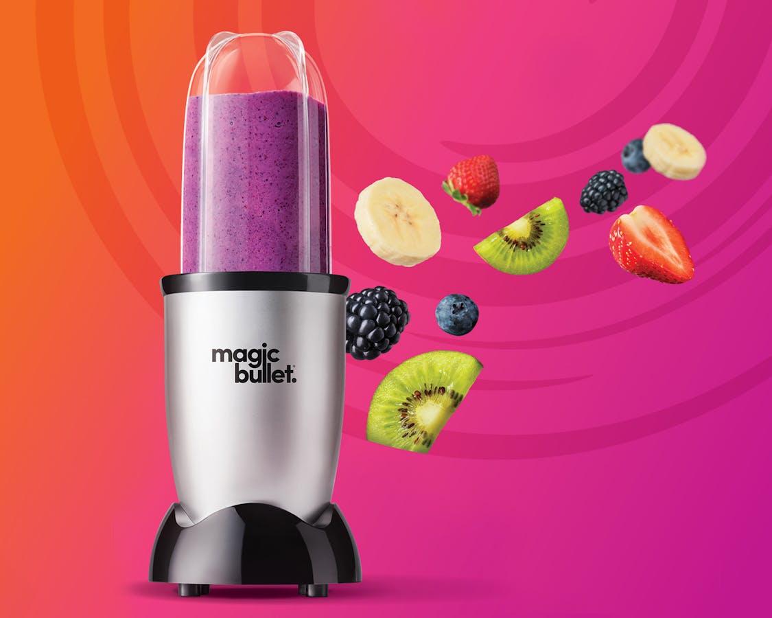 magic bullet filled with a smoothie, against a bright pink and purple background.