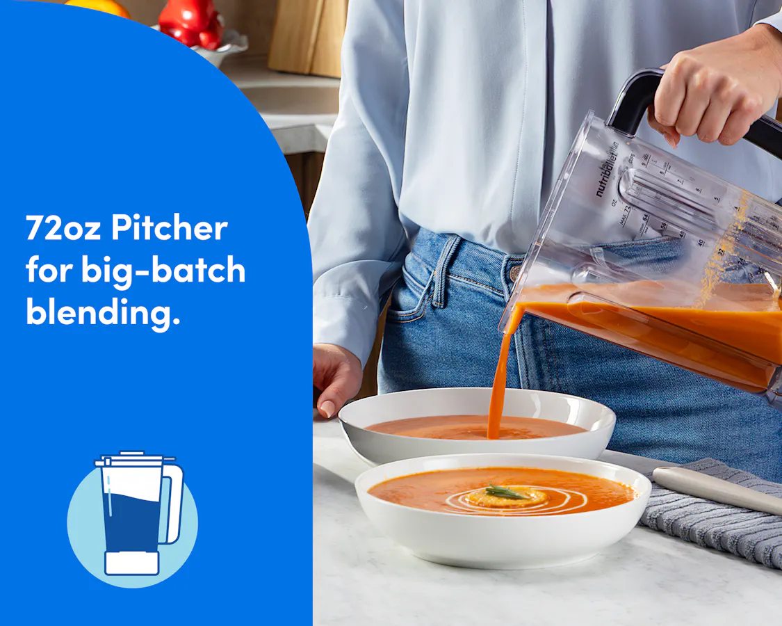 Hand pours orange soup from the nutribullet Power Core XL 72oz blender pitcher into a bowl of tomato soup.