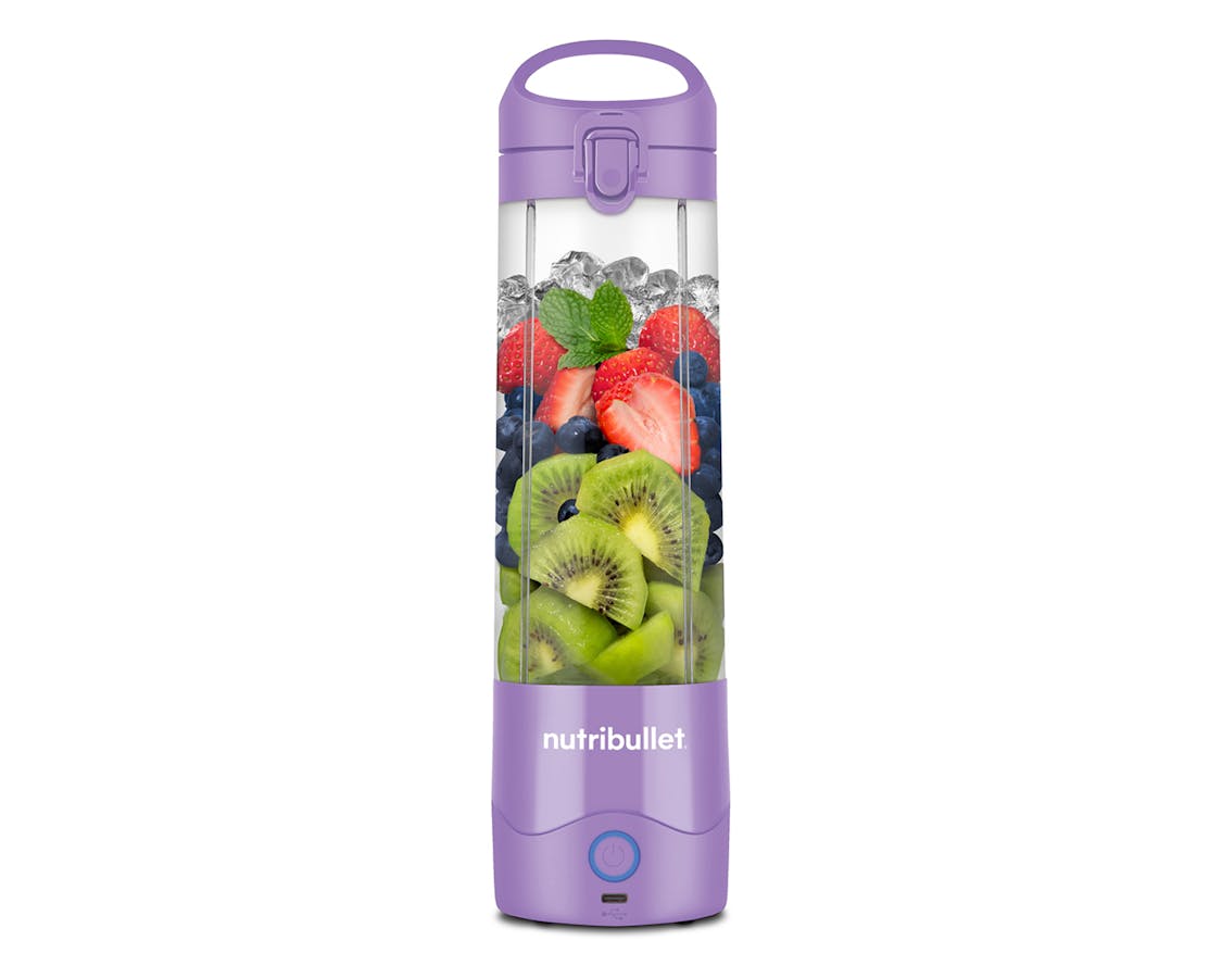 the nutribullet Portable Blender, filled with fruit, stands alone on a white background.