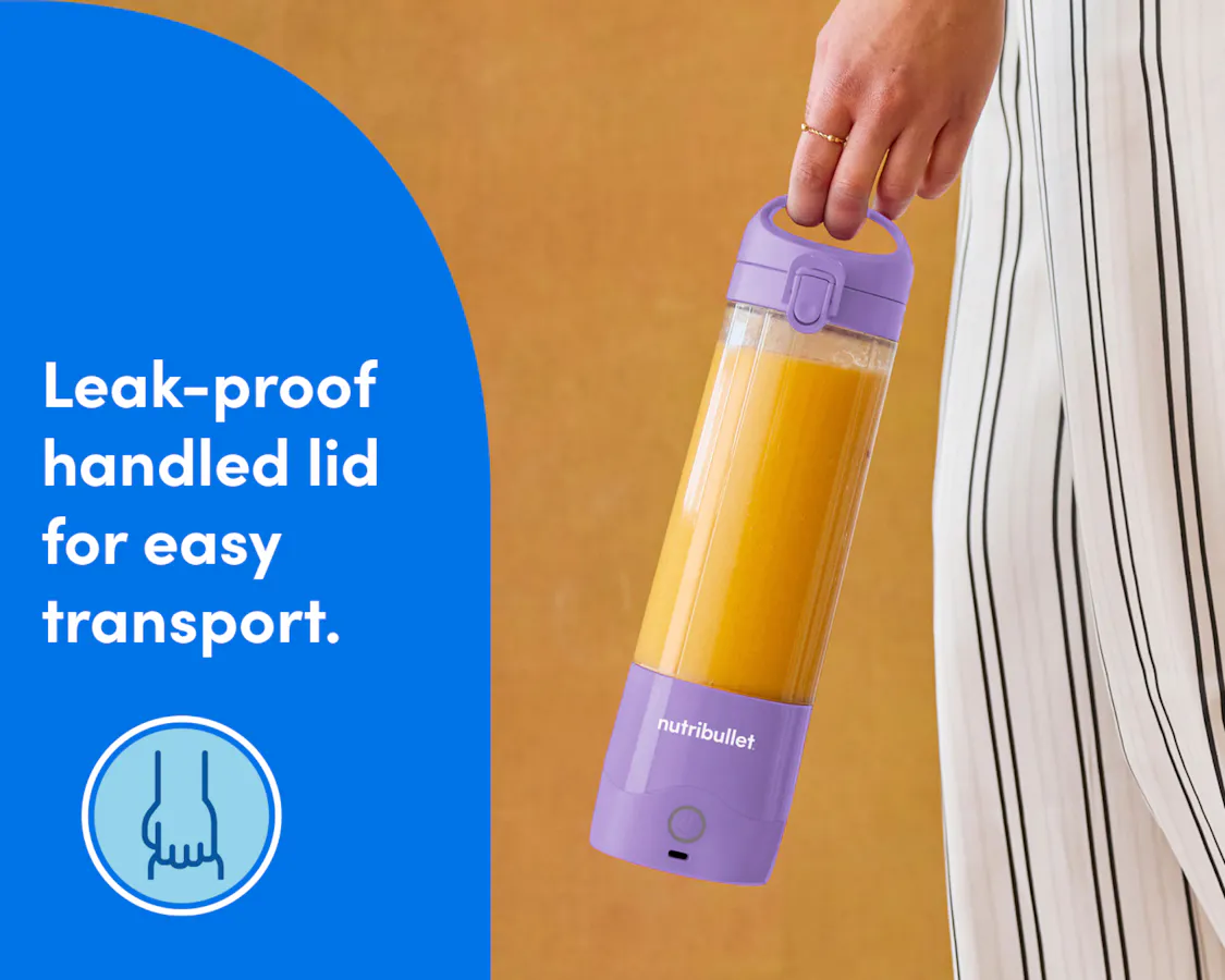 A closeup of a woman's hand, carrying the portable blender near her hip. She is wearing loose, striped white pants. A blue panel to the left of the image reads: "Leak-proof handled lid for easy transport". A circular icon beneath the text shows an illustration of a hand gripping the handled lid of the blender.