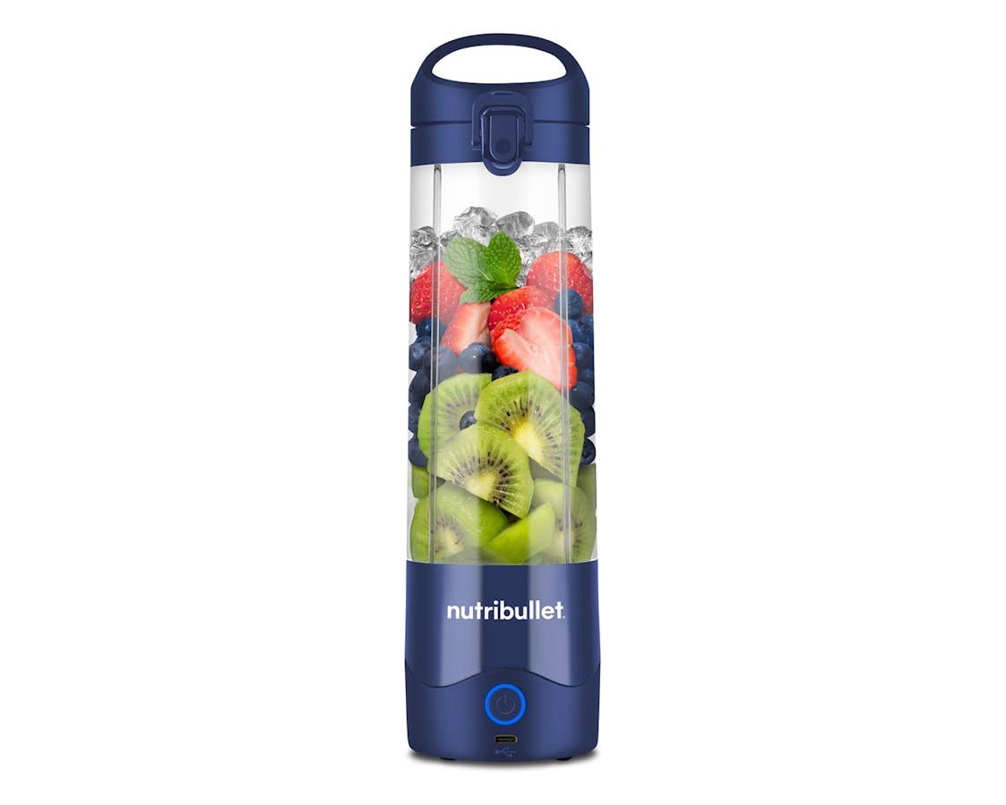 the nutribullet Portable Blender, filled with fruit, stands alone on a white background.