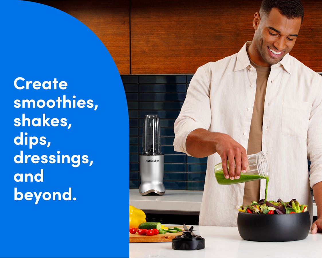 A man stands behind a kitchen island and pours green salad dressing from his nutribullet Ultra cup over a bowl full of lettuce and other vegetables. The nutribullet Ultra is seen on the countertop behind the man to his left. Tex reads: create smoothies, shakes, dips, dressings, and beyond.