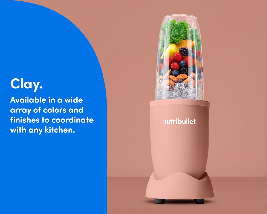 The matte Clay nutribullet Pro rests on a kitchen counter. The Tall Cup is attached to the Power Base and filled with fruit, ice, and nuts.