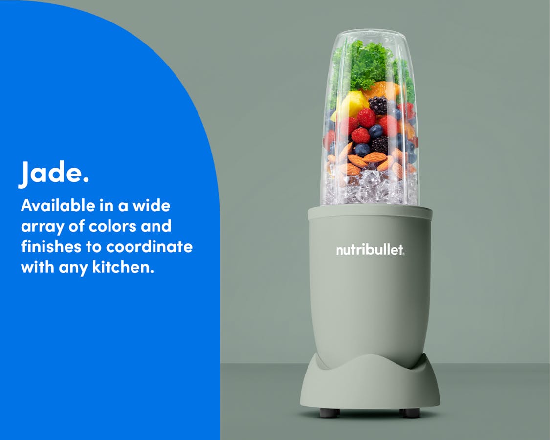 The matte Jade nutribullet Pro rests on a kitchen counter. The Tall Cup is attached to the Power Base and filled with fruit, ice, and nuts.