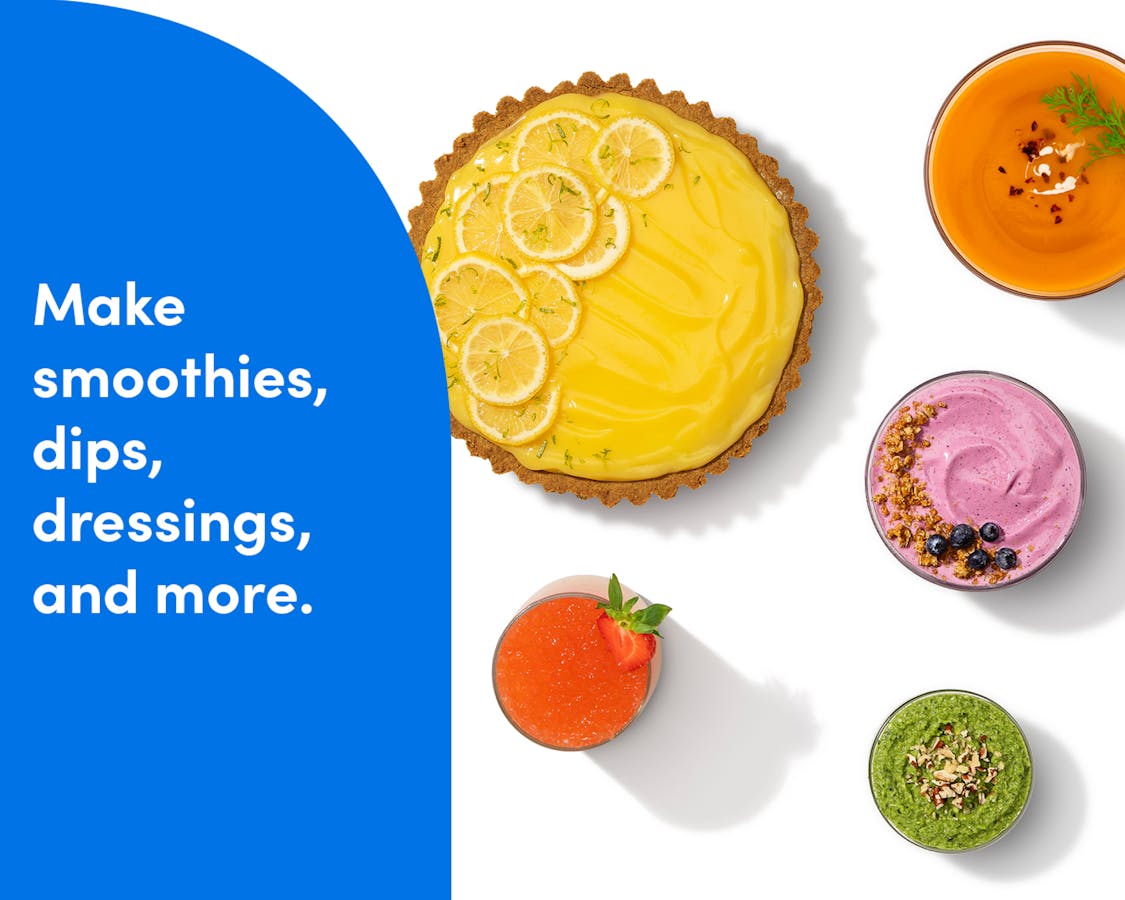 An overhead shot of colorful foods in circular containers – a lemon cream-filled tart, smoothies, and soups – on a white background. A blue panel to the left of the image reads "make smoothies, dips, dressings, and more."