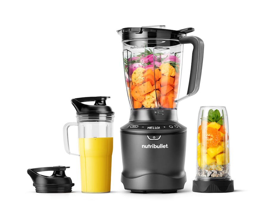 Image of the fully-assembled SmartSense Blender Combo set on a white background. The blender pitcher and accesories is filled with colorful fruits.