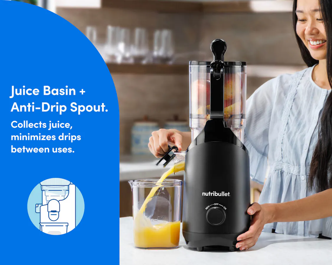 A woman lifts the spout, allowing fresh juice to flow into the juice basin.
