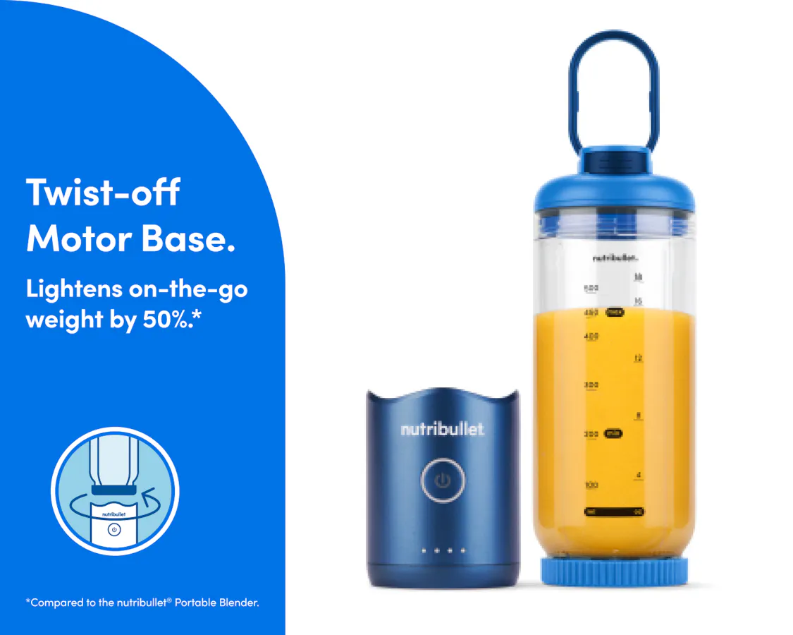 The motor base is detached and resting next to the blending cup. The cup is sealed on the bottom with the blade, and the lid is attached with the comfort handle extended.