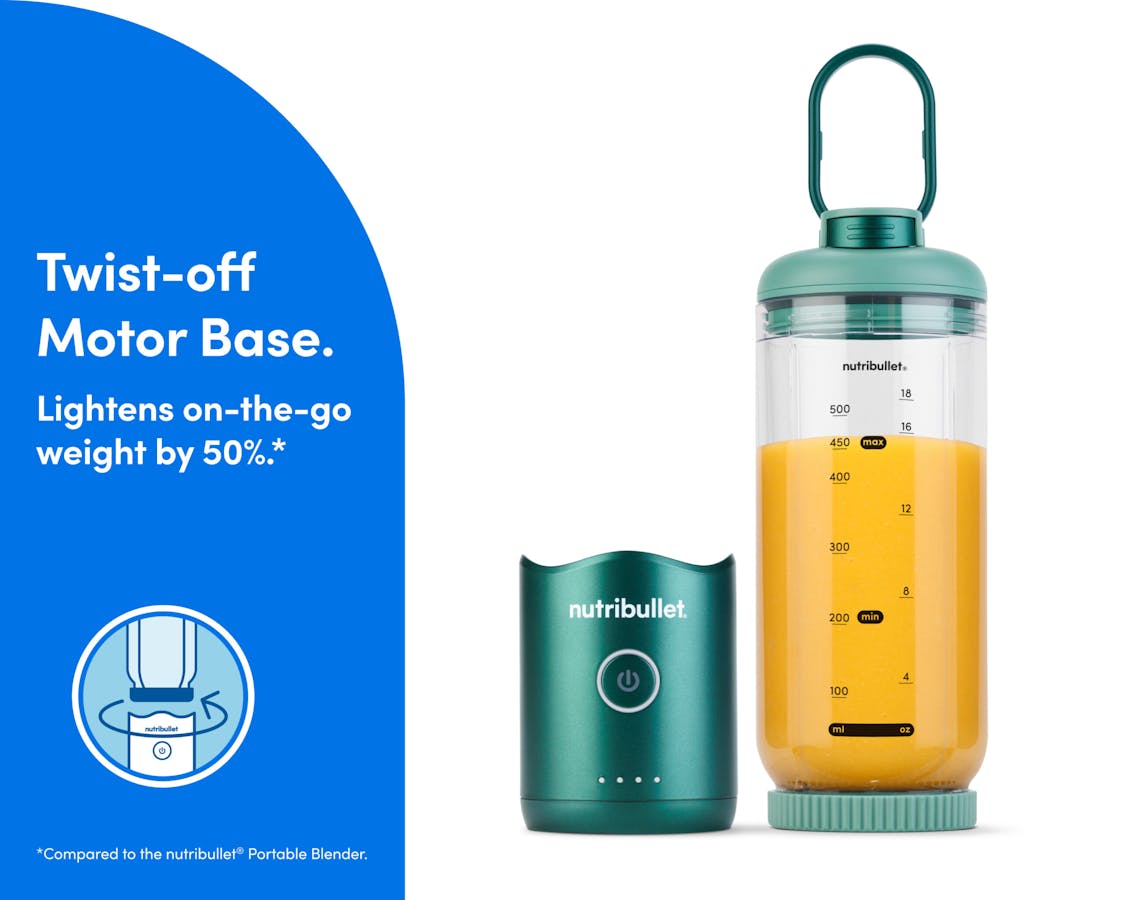 The motor base is detached and resting next to the blending cup. The cup is sealed on the bottom with the blade, and the lid is attached with the comfort handle extended.