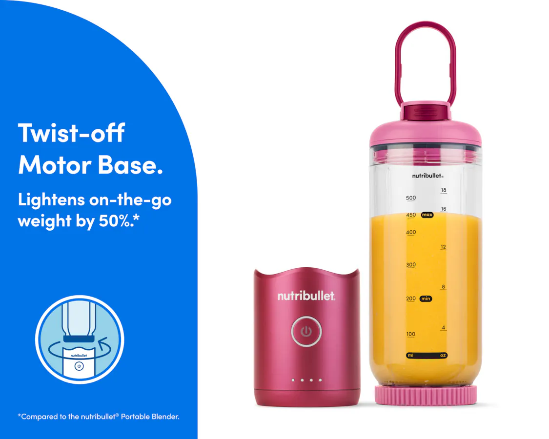The motor base is detached and resting next to the blending cup. The cup is sealed on the bottom with the blade, and the lid is attached with the comfort handle extended.