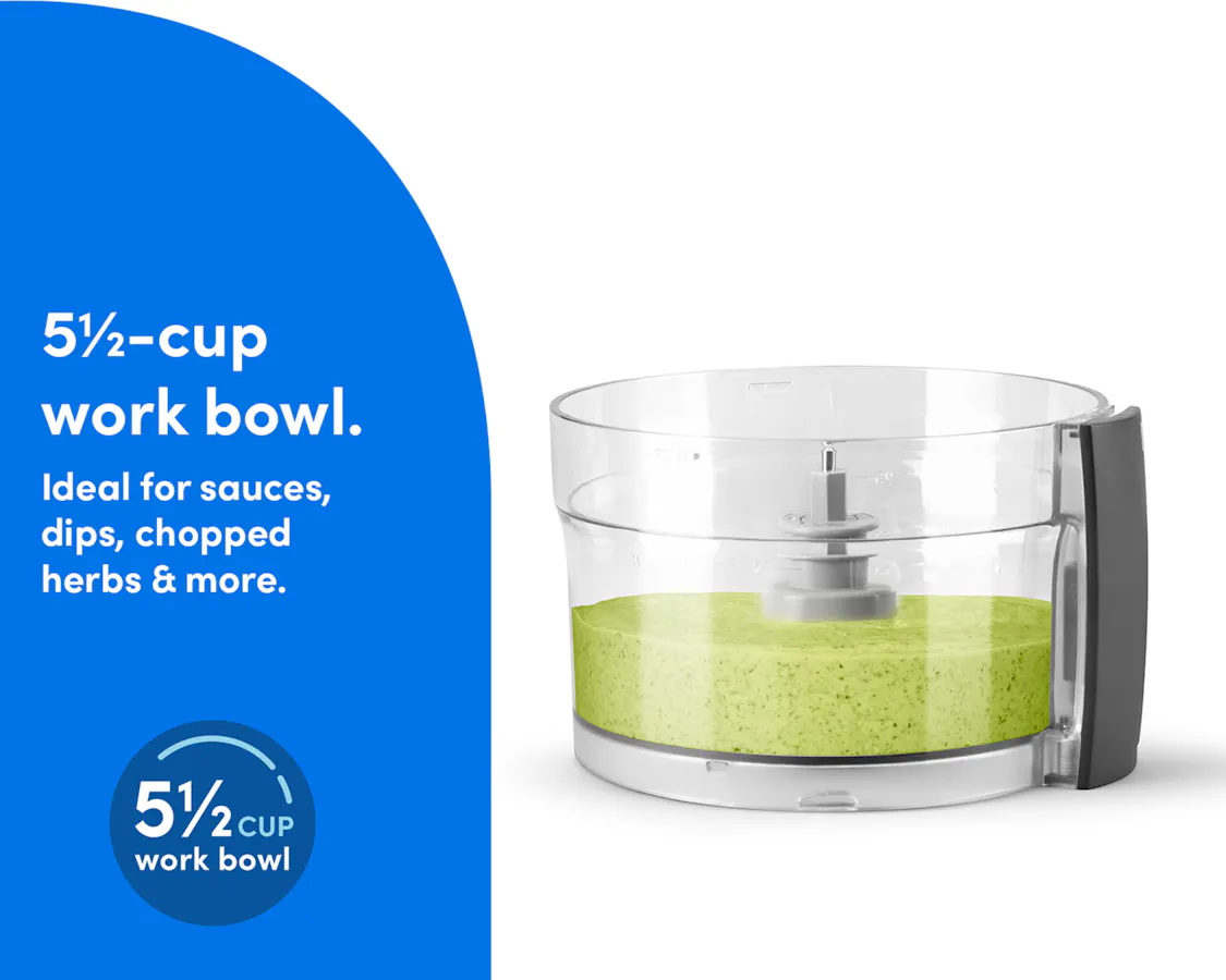 The clear work bowl of the nutribullet Limitless Food Processor filled with blended green sauce or dip.