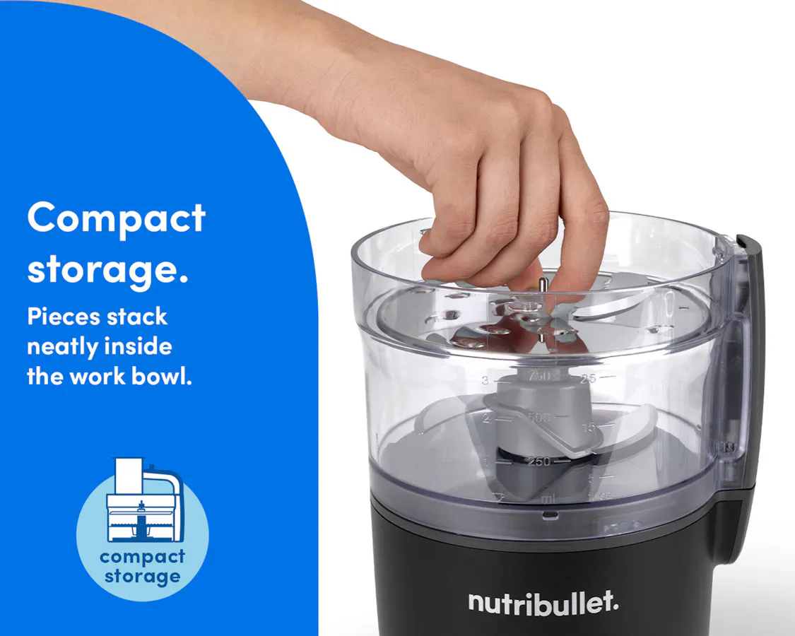 Hand placing parts inside the bowl of the nutribullet Limitless Food Processor for easy, compact storage.