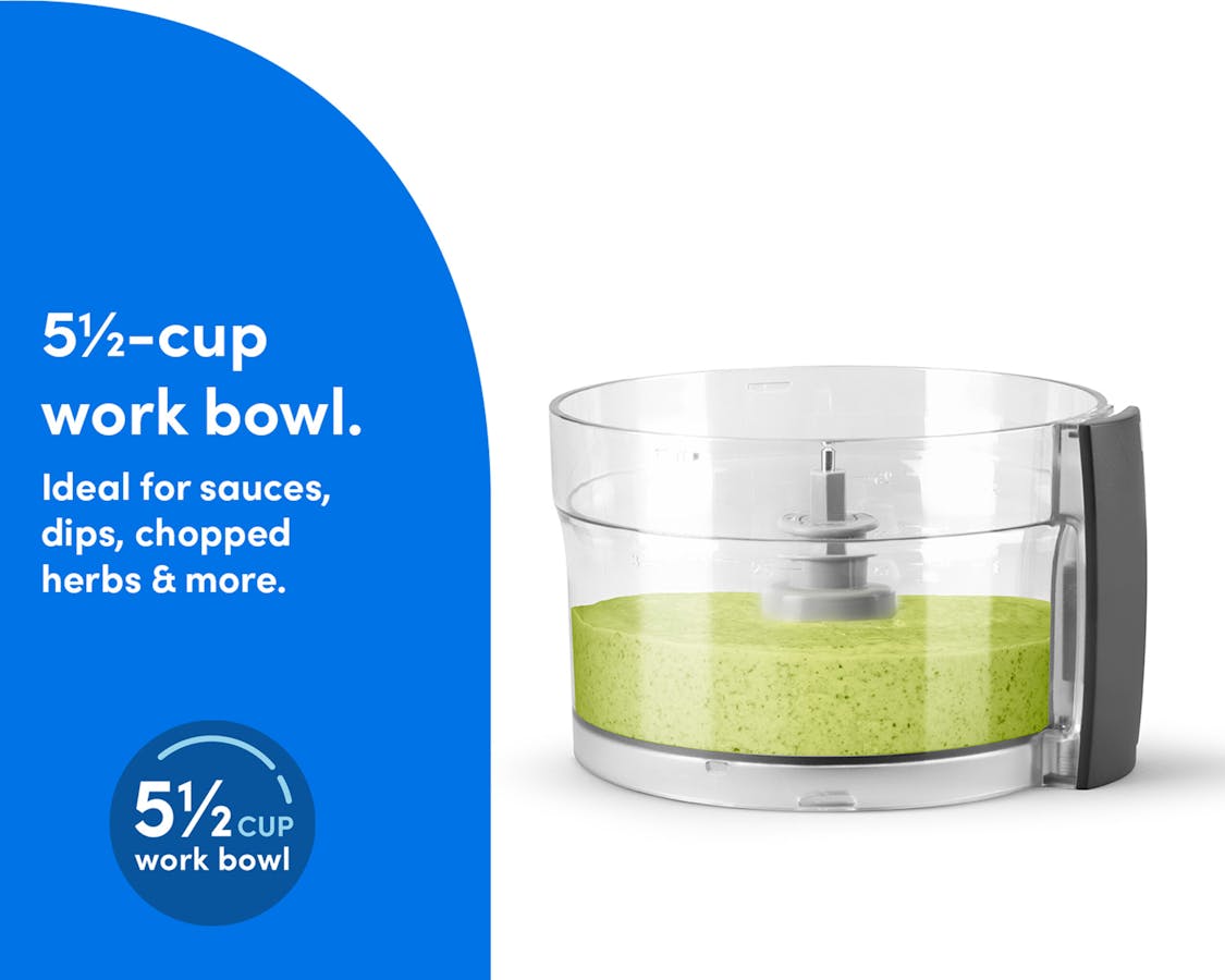 The clear work bowl of the nutribullet Limitless Food Processor filled with blended green sauce or dip.