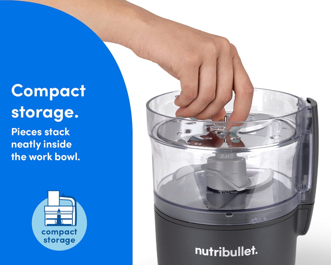 Hand placing parts inside the bowl of the nutribullet Limitless Food Processor for easy, compact storage.