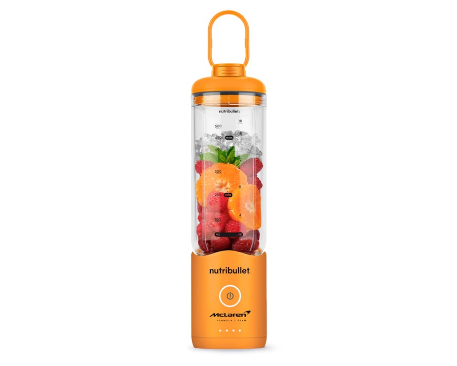 Studio product shot of the orange nutribullet Flex X McLaren Portable Blender with fruit inside the blending cup.