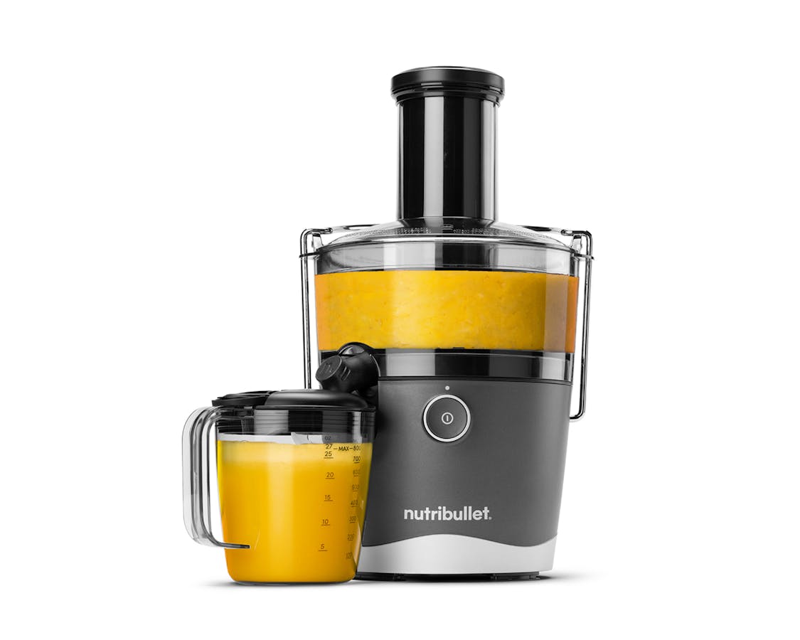 The nutribullet Juicer and pitcher with yellow juice inside on white background.