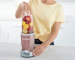 Product preview 3 of 7. Thumbnail woman using nutribullet Rose Gold to blend a smoothie