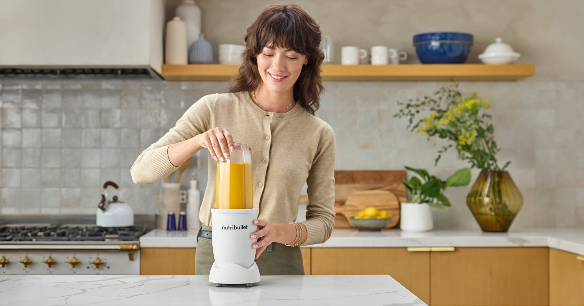 woman making smoothie in the kitchen with her nutribullet Pro