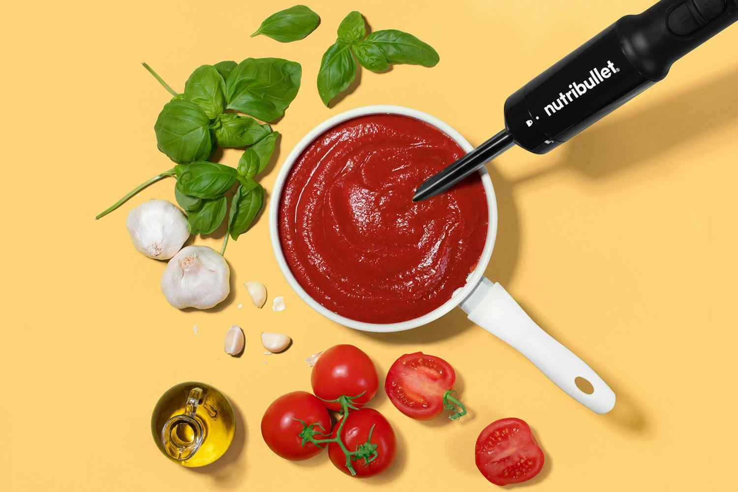 nutribullet Immersion blender making homemade tomato soup surrounded by fresh ingredients