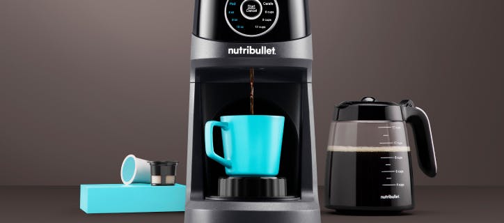 nutribullet® Brew Choice Pod brewing coffee and coffee pods on a dark gray background