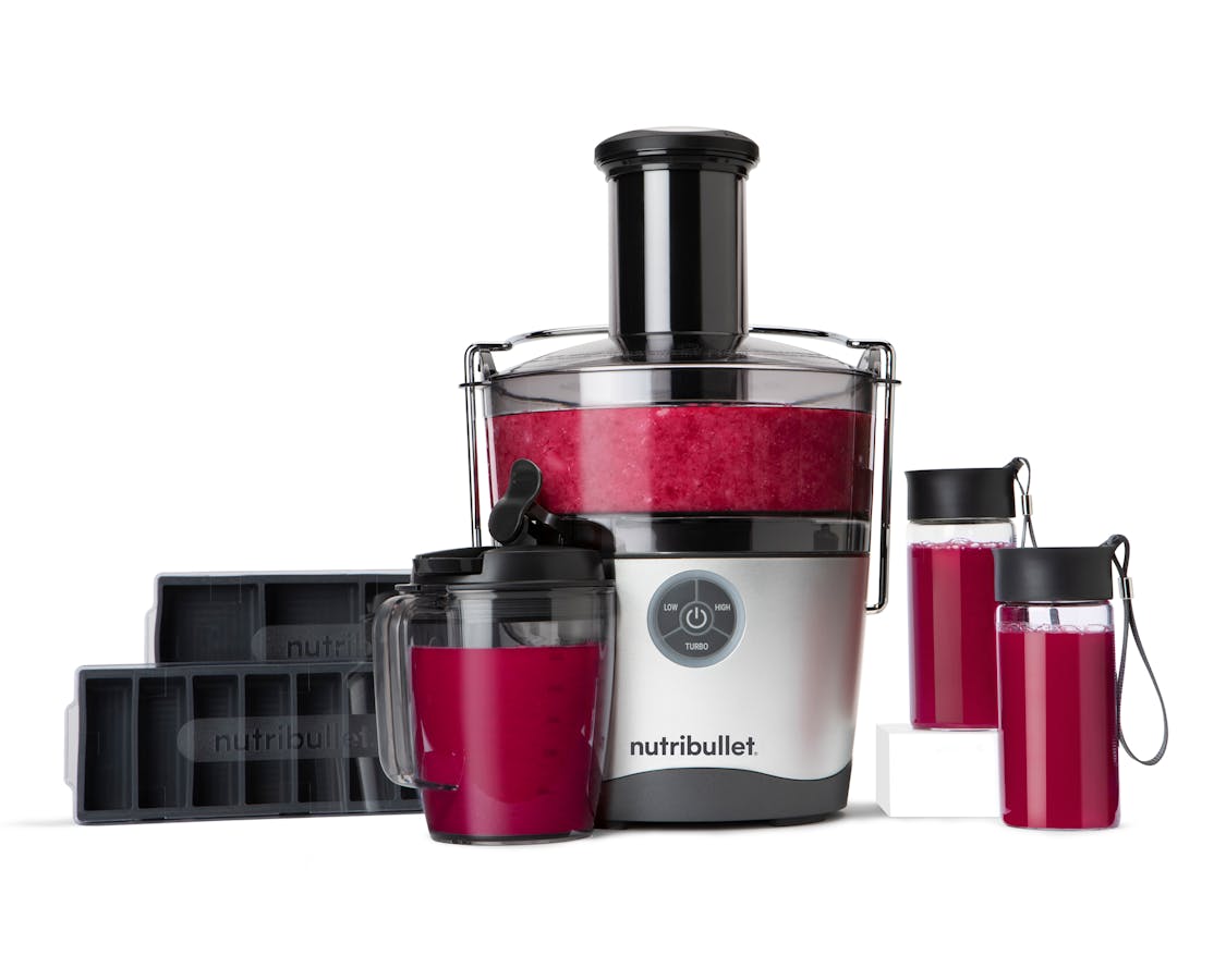 nutribullet Juicer Pro® and accessories containing a dark purple juice on white background.