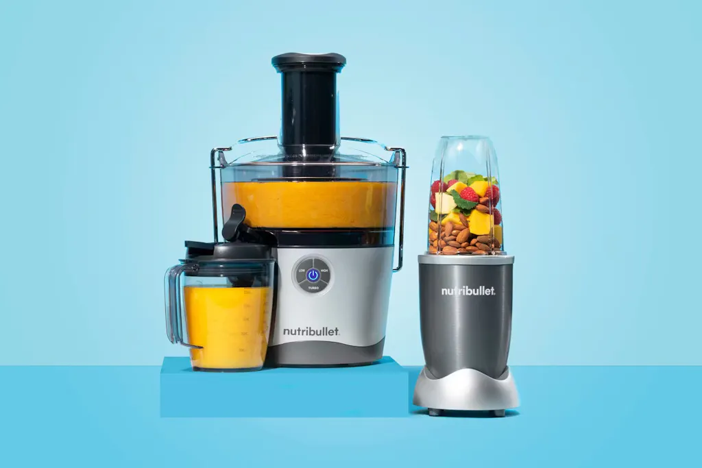 nutribullet Juicer and personal blender nutribullet juicer filled with freshly made orange juice and nutribullet personal blender filled with unblended fresh ingredients