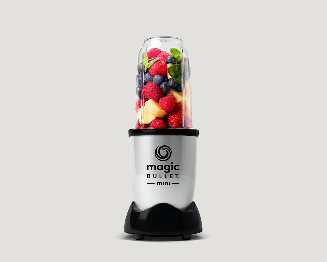magic bullet Mini filled with fruit on gray background