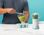 Product preview 3 of 7. Thumbnail nutribullet Baby with batchbowl and freezer tray on blue background.