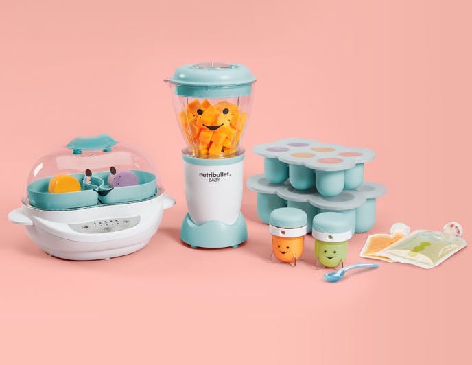 Blue and white baby blender, steamer, meal prep kit with smiley faces on light pink background.