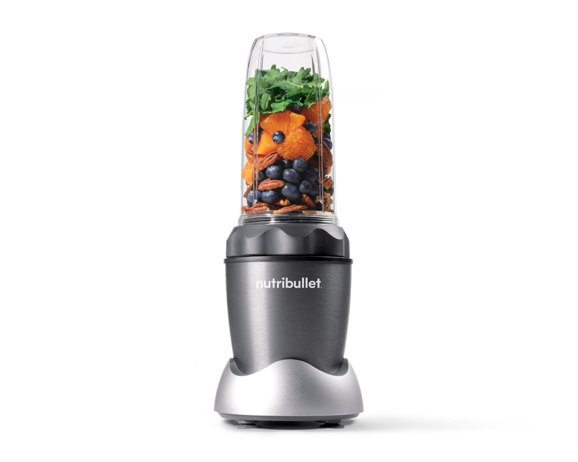 nutribullet PRO 1000 with fruits, vegetables, and nuts on white background.