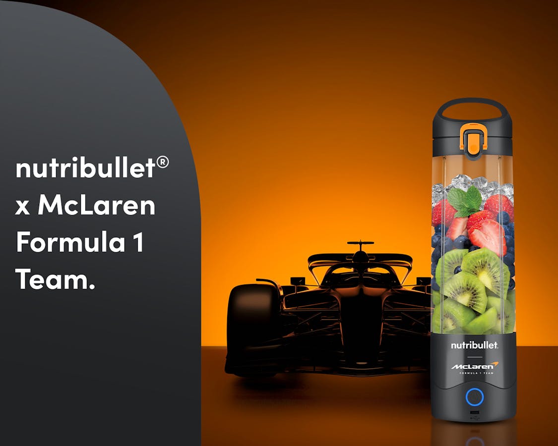 The nutribullet® x McLaren: Portable with fresh fruit and a Formula 1 car in the back. A gray panel reads "nutribullet® x McLaren Formula 1 Team".