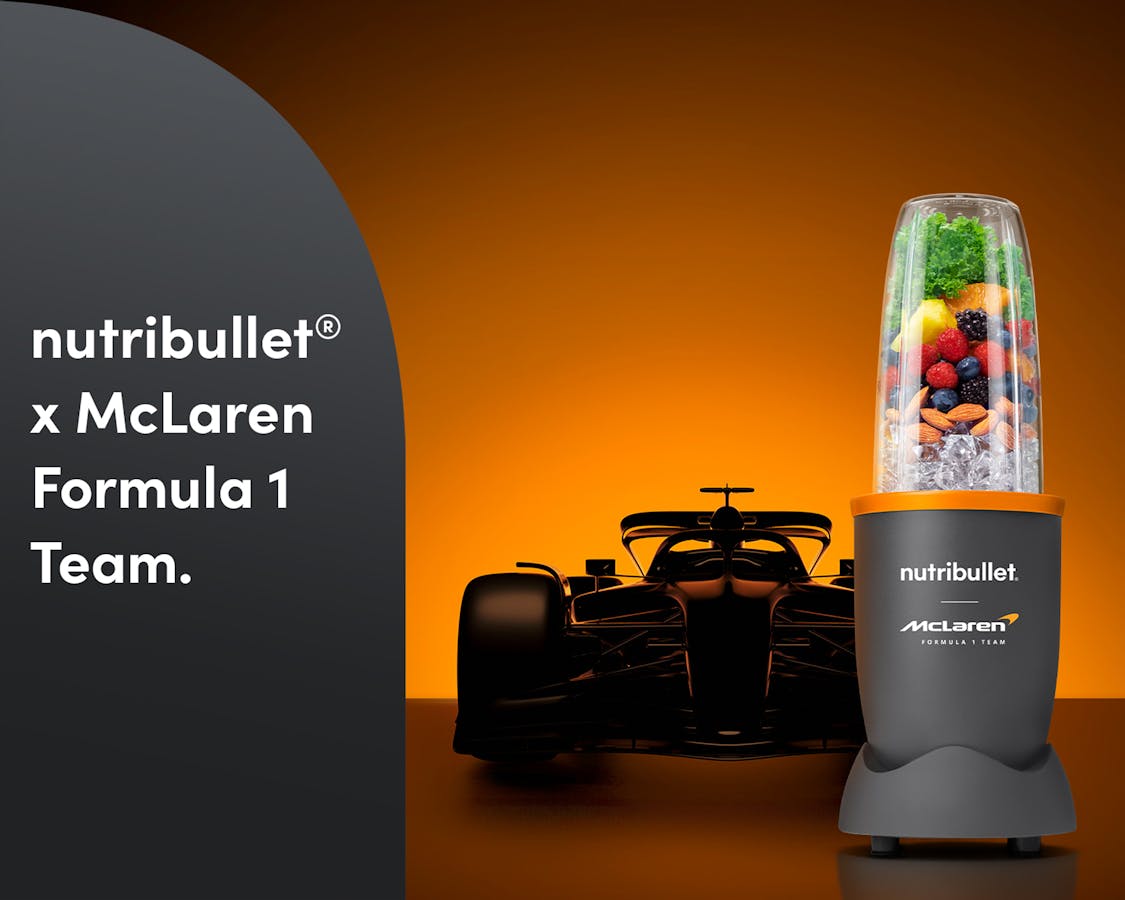 The nutribullet® x McLaren: Pro with fruit, nuts and ice with a Formula 1 car in the back. A gray panel reads "nutribullet® x McLaren Formula 1 Team".