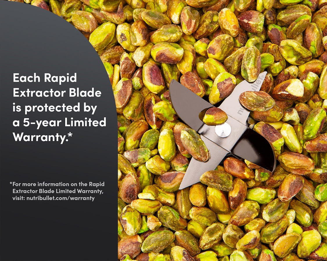 Whole peeled pistachios with nutribullet blades in the middle. A gray panel reads "Each Rapid Extractor Blade is protected by a 5-year Limited Warranty.*"