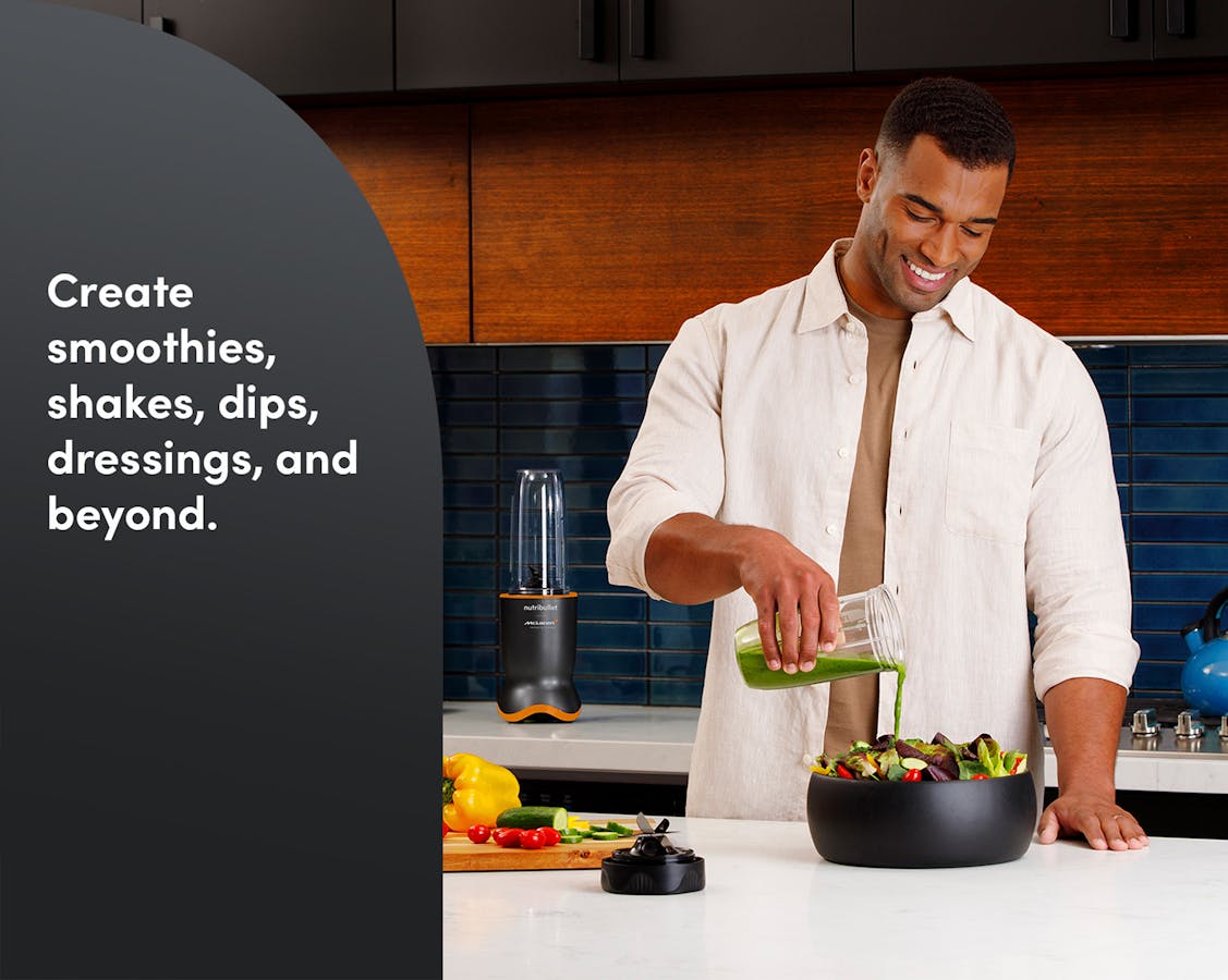 Man in a kitchen pours dressing on a salad with the nutribullet® x McLaren: Ultra in the back. A gray panel with text describes what the blender can make.