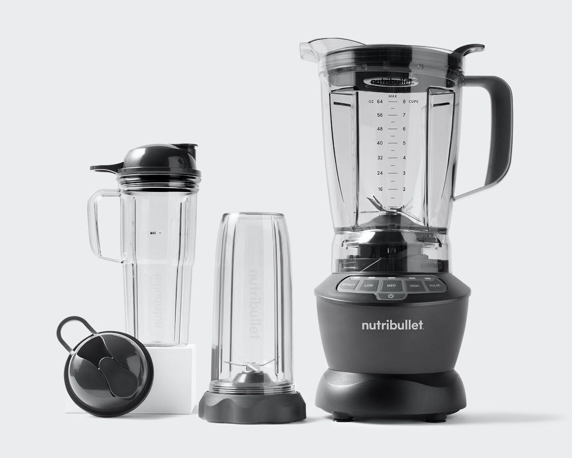nutribullet Blender Combo with 32 oz cup, 24 oz handled cup and to-go lids on grey background.