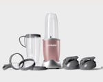 Product preview 4 of 7. Thumbnail nutribullet Rose Gold with 2 lids, 2 cups, 2 cup rings, and 2 handled lip rings.