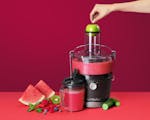 Product preview 2 of 7. Thumbnail juicer with fruit and vegetables on red background.