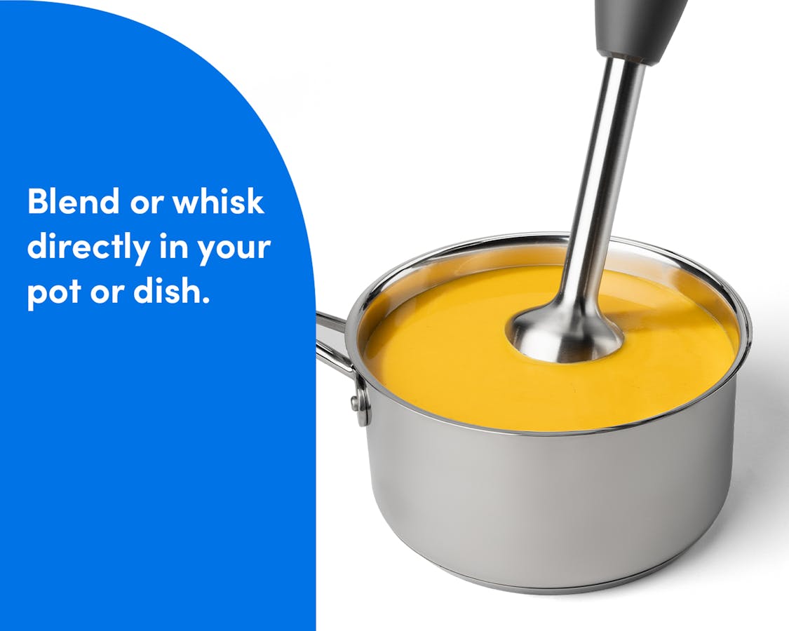 Blending Directly in a Pot The nutribullet Lite immersion blender mixing a pot of orange soup, demonstrating its ability to blend ingredients directly in the dish.