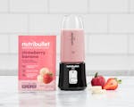 Product preview 3 of 10. Thumbnail of strawberry banana Ready-To-Blend Smoothie packet with black nutribullet GO filled with smoothie.