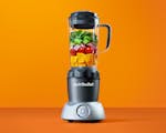 Product preview 1 of 9. Thumbnail nutribullet with fruits and vegetables on orange background.