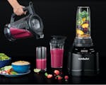 Product preview 3 of 8. Thumbnail of black nutribullet Blender Combo with extra pitchers and cups filled with fruit, smoothies and spread of food.