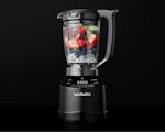 Product preview 2 of 8. Thumbnail of nutribullet Smart Touch blender filled with ice, strawberries, blueberries and greens on a black background.