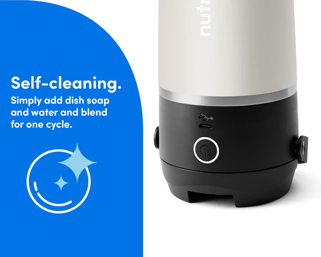 Zoomed-in image of the Linen nutribullet Flip resting with the blade on the bottom with the blending button illuminated. Self-cleaning, simply add dish soap and water and blend for one cycle.